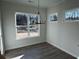 Bright dining area featuring large windows and a modern chandelier at 1109 Cooks Farm Way, Woodstock, GA 30189