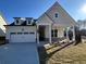 Charming two-story home with a well-manicured lawn, a two car garage, and inviting front porch at 1109 Cooks Farm Way, Woodstock, GA 30189