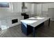 Modern kitchen boasts white cabinets, stainless steel appliances, and a large island at 1109 Cooks Farm Way, Woodstock, GA 30189