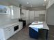 Modern kitchen boasts white cabinets, stainless steel appliances, and a large island at 1109 Cooks Farm Way, Woodstock, GA 30189