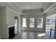 Open living room featuring a fireplace, recessed lighting, and a tray ceiling at 1109 Cooks Farm Way, Woodstock, GA 30189