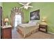 Bright bedroom with a double bed and green walls at 1409 Woodmere Ct, Mcdonough, GA 30252