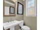 Small powder room with pedestal sink and window at 3179 Clairebrooke Ave, Atlanta, GA 30341