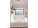Relaxing bathroom with a large jetted tub and window view at 4222 Honey Creek Way, Powder Springs, GA 30127