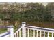 Deck overlooks peaceful lake and tree-lined landscape at 4222 Honey Creek Way, Powder Springs, GA 30127
