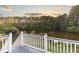 Deck overlooks peaceful lake and tree-lined landscape at 4222 Honey Creek Way, Powder Springs, GA 30127