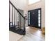 Elegant entryway with black staircase and light flooring at 4222 Honey Creek Way, Powder Springs, GA 30127