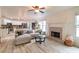 Open concept living room with a fireplace and kitchen view at 4222 Honey Creek Way, Powder Springs, GA 30127