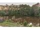Serene pond view with lush greenery and tree line at 4222 Honey Creek Way, Powder Springs, GA 30127