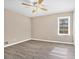 Well-lit bedroom with wood-look floors and a ceiling fan at 6747 Rockland Rd, Lithonia, GA 30038
