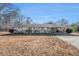 Ranch-style home with carport and mature trees at 6747 Rockland Rd, Lithonia, GA 30038