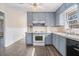 Galley kitchen with gray cabinets and white appliances at 6747 Rockland Rd, Lithonia, GA 30038