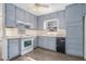 Kitchen with gray cabinets and wood-look floors at 6747 Rockland Rd, Lithonia, GA 30038