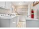 Laundry area with washer, dryer, and ample storage at 6747 Rockland Rd, Lithonia, GA 30038