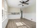 Spacious living room featuring wood-look floors and kitchen view at 6747 Rockland Rd, Lithonia, GA 30038