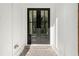 Black double front doors with glass panes and brick walkway at 3910 W Cooper Lake Se Dr, Smyrna, GA 30082
