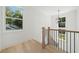 Elegant staircase with light wood railings and a modern light fixture at 3910 W Cooper Lake Se Dr, Smyrna, GA 30082