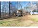 Backyard view featuring an elevated playhouse with stairs and a swing at 4801 Daniel Mill Rd, Winston, GA 30187
