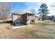View of a sprawling backyard featuring a screened-in porch and patio area at 4801 Daniel Mill Rd, Winston, GA 30187