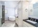 Well-lit bathroom features a standalone tub, dual sinks, and a glass-enclosed shower at 4801 Daniel Mill Rd, Winston, GA 30187