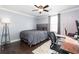 Cozy bedroom features dark wood floors, a large bed, and study space at 4801 Daniel Mill Rd, Winston, GA 30187