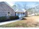 Side view of a brick house with a sidewalk leading to the porch and a well-kept lawn at 4801 Daniel Mill Rd, Winston, GA 30187