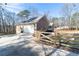 Side exterior view of home with an attached garage and fenced yard at 4801 Daniel Mill Rd, Winston, GA 30187