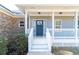 Inviting front porch with white railings and a charming blue front door with decorative wreath at 4801 Daniel Mill Rd, Winston, GA 30187