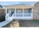 Charming front porch with white railings and a blue front door at 4801 Daniel Mill Rd, Winston, GA 30187