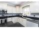 Kitchen showcases stainless appliances, dark countertops, and white cabinets at 4801 Daniel Mill Rd, Winston, GA 30187