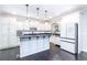 Bright kitchen features white cabinetry, stainless appliances, and an island with dark countertops at 4801 Daniel Mill Rd, Winston, GA 30187