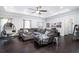 Spacious living room with dark hardwood floors, a cozy sectional sofa, and a hanging chair at 4801 Daniel Mill Rd, Winston, GA 30187