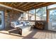 Inviting outdoor porch featuring a swing, fireplace, and wood pile at 4801 Daniel Mill Rd, Winston, GA 30187