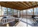 Comfortable screened porch includes furniture and view of the wooded backyard at 4801 Daniel Mill Rd, Winston, GA 30187