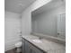 Bathroom with granite counters, modern vanity, large mirror and shower/tub with white walls and neutral floors at 250 Shawnee Trl, Dallas, GA 30157