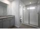 Bathroom featuring double sinks with granite countertops and a glass-enclosed shower at 250 Shawnee Trl, Dallas, GA 30157