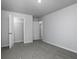 Neutral bedroom features carpet, light grey walls, trim and an open closet with shelving for storage at 250 Shawnee Trl, Dallas, GA 30157