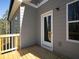 Side view of outdoor wooden deck that can be accessed through a white glass door off the side of the home at 250 Shawnee Trl, Dallas, GA 30157