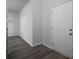 Light filled entryway features wood-look flooring, neutral paint and a view into the hall at 250 Shawnee Trl, Dallas, GA 30157