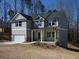 Gray home with a covered porch, and a two car garage provides an inviting curb appeal at 250 Shawnee Trl, Dallas, GA 30157