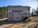 Back exterior shot of home shows wooden deck, roof, vinyl siding, windows and backyard view of the landscape at 250 Shawnee Trl, Dallas, GA 30157