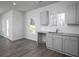 Open-concept kitchen features gray cabinets, granite countertops, and lots of natural light at 250 Shawnee Trl, Dallas, GA 30157