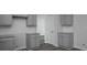 Well-lit kitchen boasts gray cabinets, granite countertops, and lots of storage space at 250 Shawnee Trl, Dallas, GA 30157
