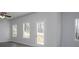The light and airy living room features multiple windows and a door leading to a deck at 250 Shawnee Trl, Dallas, GA 30157