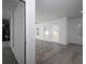 Open-concept living room has wood-look floors, white walls, and a view to the backyard at 250 Shawnee Trl, Dallas, GA 30157