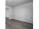The living room features wood-look flooring and a view into the hallway at 250 Shawnee Trl, Dallas, GA 30157