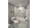 Modern bathroom with tiled shower and floors and sleek black fixtures at 2715 Heritage Ln, Morrow, GA 30260