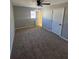 A cozy bedroom with a window letting in natural light, fan and carpet at 2715 Heritage Ln, Morrow, GA 30260
