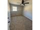 Neutral bedroom with window, closet, ceiling fan and carpet floor at 2715 Heritage Ln, Morrow, GA 30260