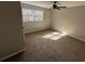 A cozy bedroom with a window letting in natural light, fan and carpet at 2715 Heritage Ln, Morrow, GA 30260
